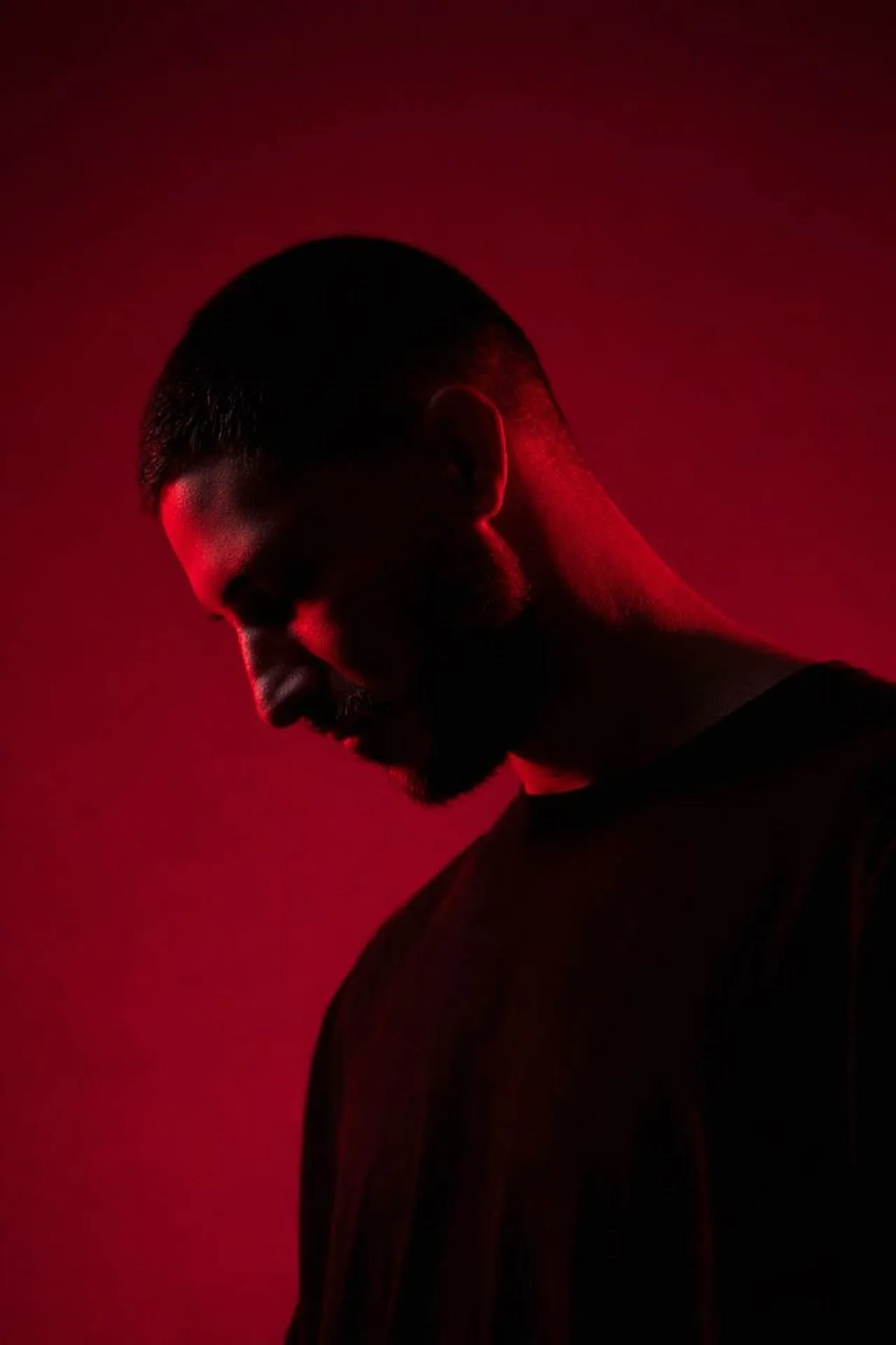 ASTR, portrait lit in deep red